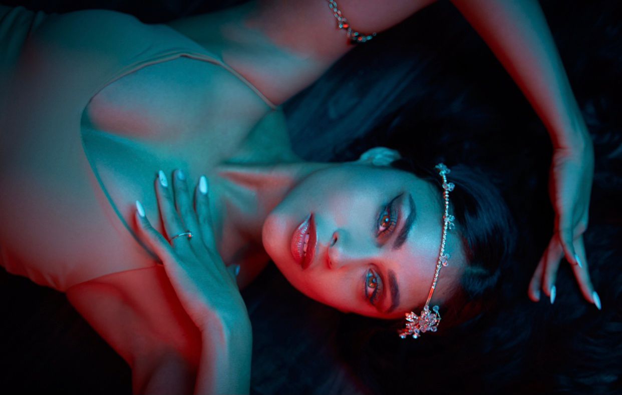 Viviana standing in the jungle with floating leaves